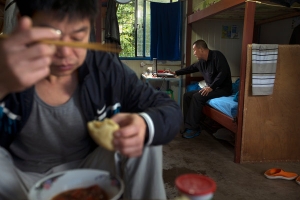Chinese men, in Ecuador for the Coca Codo Sinclair hydroelectric project, in their room in a camp for workers. Credit Ivan Kashinsky for The New York Times